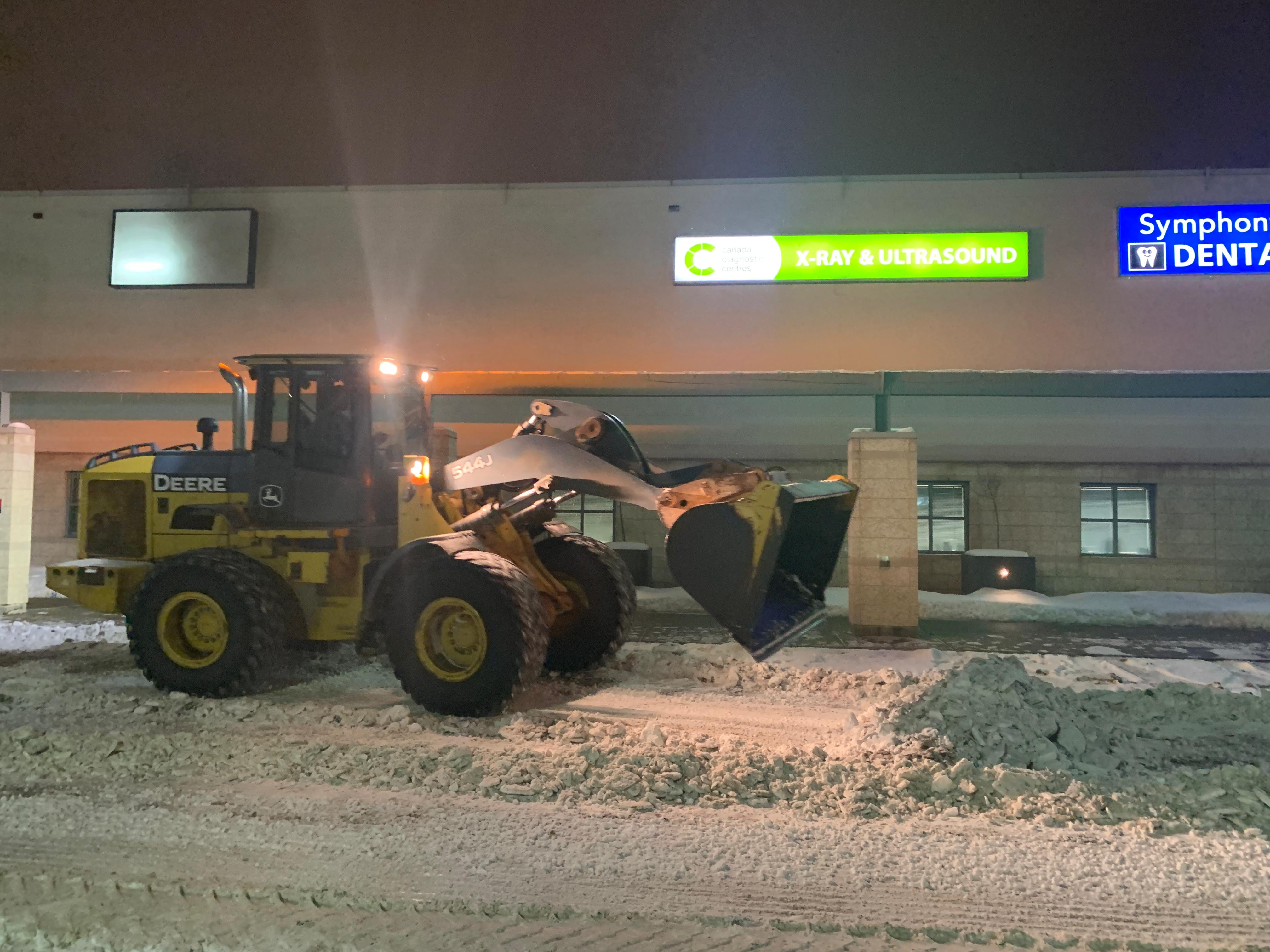 ALA Landscaping heavy equipment loader performing site demolition and clearing work